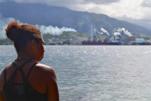 Woman looking at ocean dumping site in Papua New Guinea